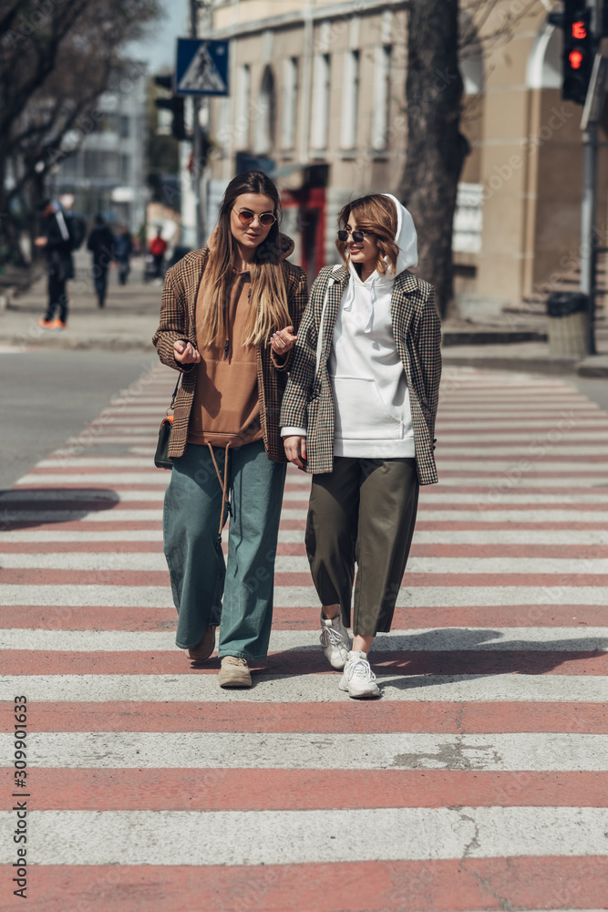 Portrait of Two Fashion Girls, Best Friends Outdoors, Walking at Road Crossing