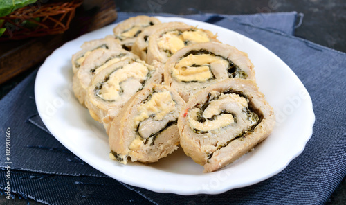 Baked turkey rolls with spinach, mozzarella on plate. Healthy tasty lunch. New Year and Christmas appetizer. © yaroshenko