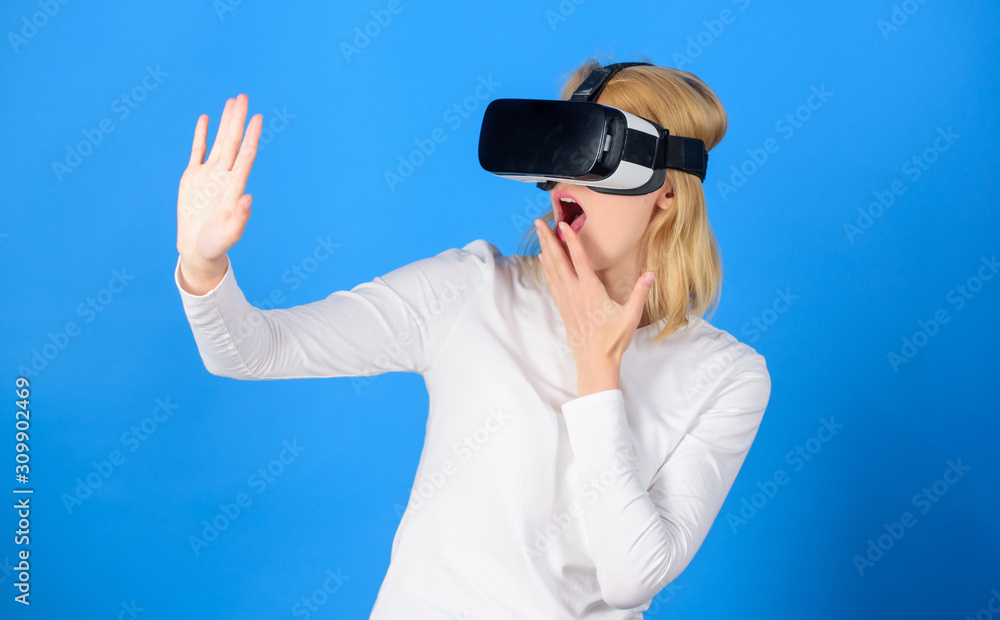 Woman wearing virtual reality goggles. Person with virtual reality helmet isolated on blue background.Woman with virtual reality headset. Virtual reality isolated. Woman wearing virtual reality goggles. Person with virtual reality helmet isolated on blue background.Woman with virtual reality headset. Virtual reality isolated.