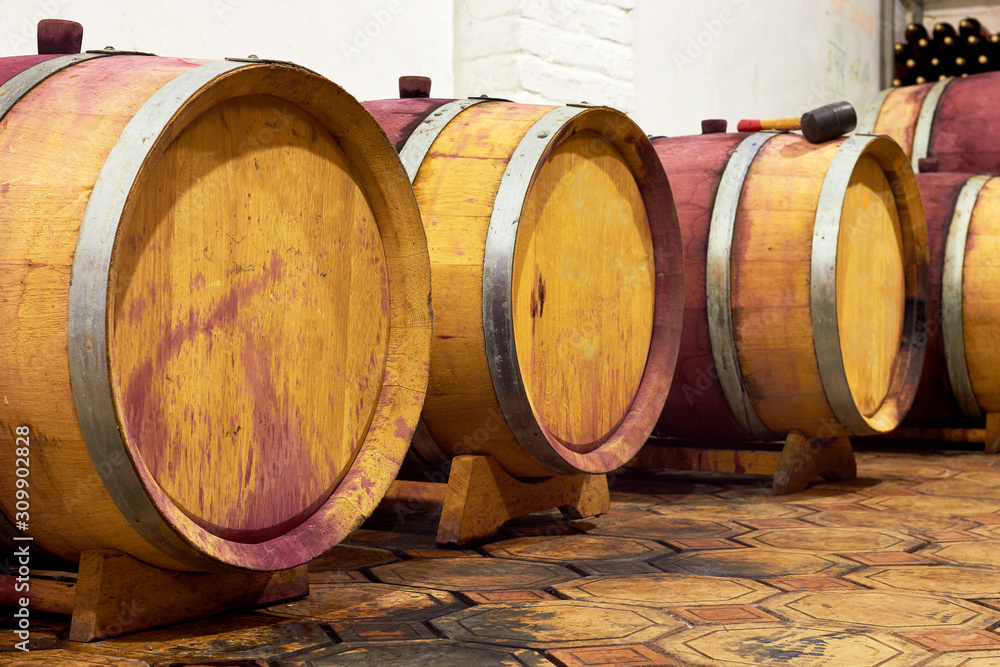 Oak barrels with wine in the old wine cellar