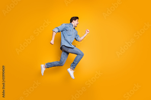 Side profile photo of cheerful positive man screaming after seeing sales beginning isolated in white footwear over vivid color background