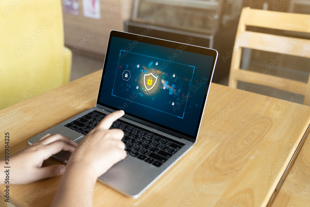 Fototapeta premium Person using a Laptop Computer with data protection, Cyber security, information safety and encryption concept. internet technology and business concept, Laptop mockup with clipping path on screen.