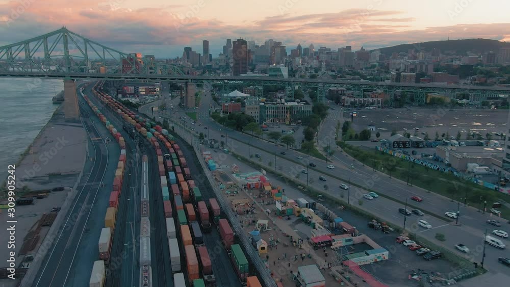 AERIAL: The railway, rush hour traffic, Pont Jacques-Cartier bridge, Saint Lawrence River and Montreal Skyline, Quebec, Canada AERIAL: The railway, rush hour traffic, Pont Jacques-Cartier bridge, Saint Lawrence River and Montreal Skyline, Quebec, Canada