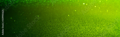 green Sparkling Lights Festive background with texture. Abstract Christmas twinkled bright bokeh defocused