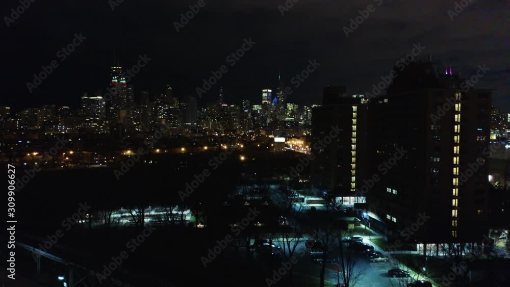 Aerial - Drone Ascends to Reveal City Skyline on Cold Night Aerial - Drone Ascends to Reveal City Skyline on Cold Night