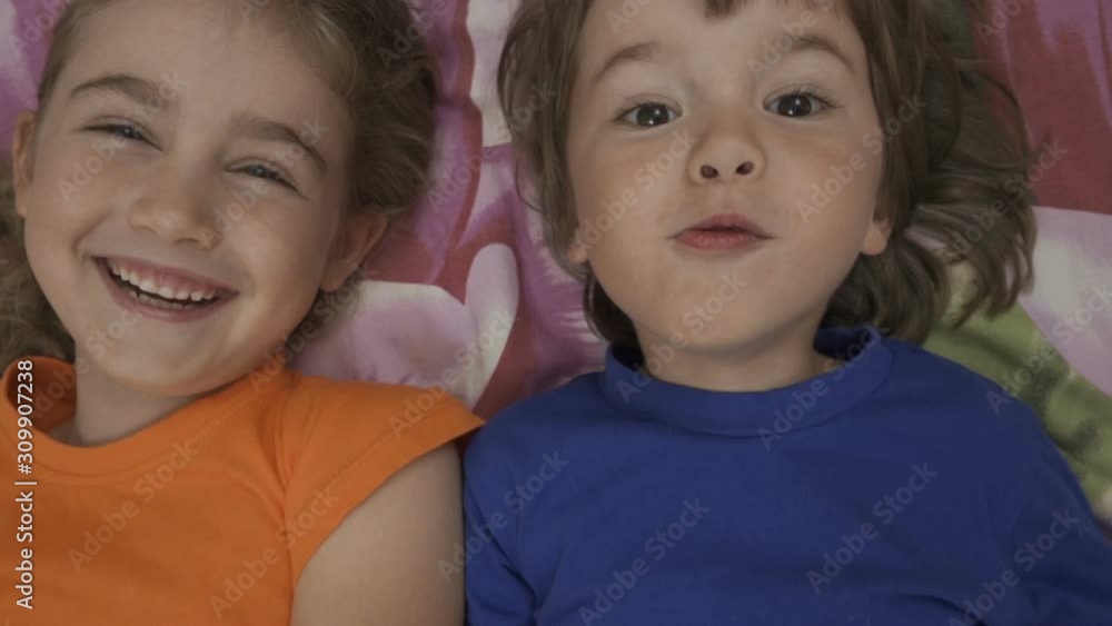 Happy Vlogger. Making Video Call. Friends Selfie. Excited Children Playing Lying on Bed and Taking Selfie. Little Brother and Sister Monkeying on Looking Camera.Taking Selfie Smartphone. Close up. Happy Vlogger. Making Video Call. Friends Selfie. Excited Children Playing Lying on Bed and Taking Selfie. Little Brother and Sister Monkeying on Looking Camera.Taking Selfie Smartphone. Close up.