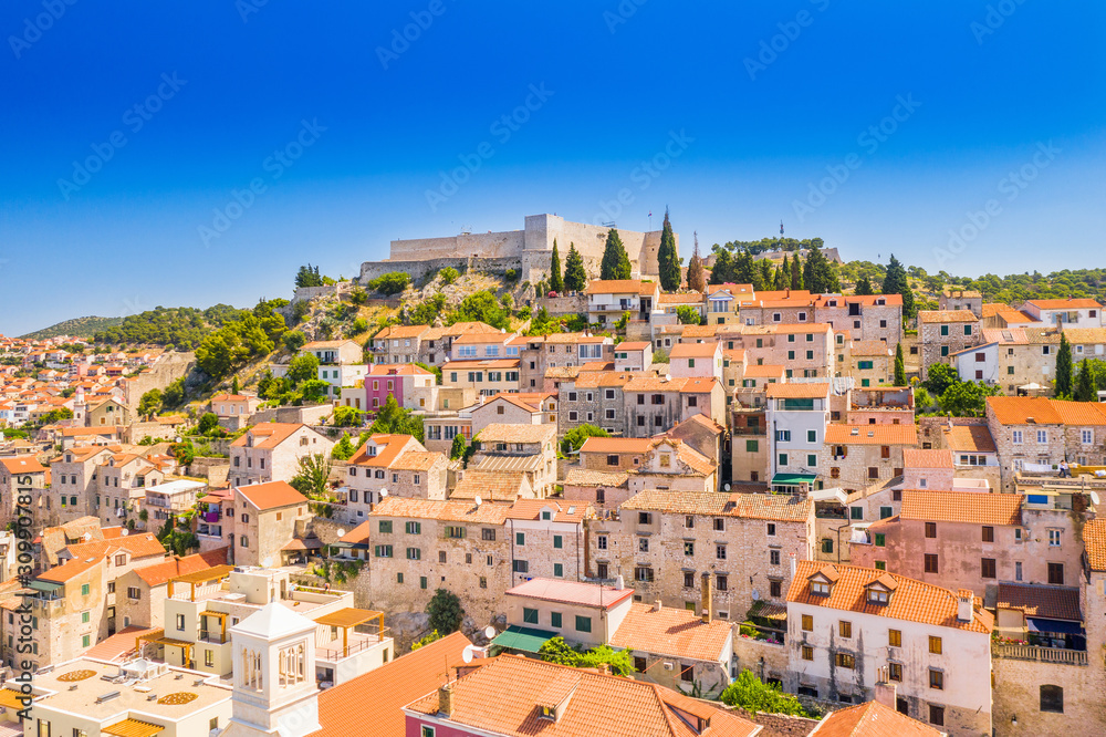Croatia, beautiful old city of Sibenik, panoramic view of the town center, houses on hills and fortress of St Michael over the city