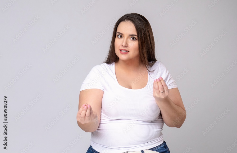 Plus Size Model with long hair meditates in studio. Plus Size Model with long hair meditates in studio.