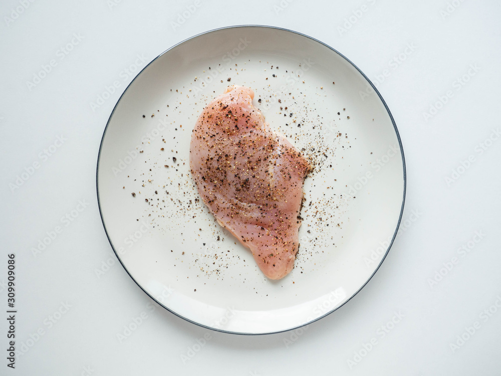 Fresh chicken breast Topping black pepper on dish White,White background Fresh chicken breast Topping black pepper on dish White,White background