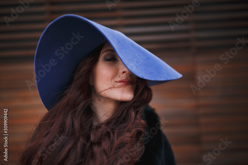 Beautiful charming young woman in a blue hat.