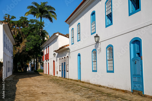 Typical cobblestone street covered with mud from high tide with colonial buildings on a sunny day in historic town Paraty, Brazil © Uwe Bergwitz