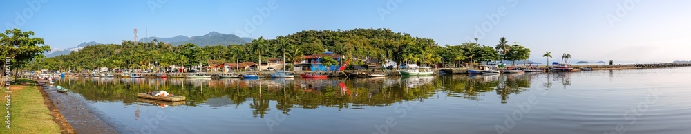 Aerial panorama of estuary of river Perequê-Açu and area Pontal with mirror reflections of morning sun in Unesco World Heritage town Paraty, Brazil