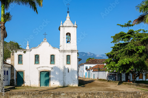 Arial view of church Nossa Senhora das Dores (Our Lady of Sorrows) wit trees on a sunny day, historic town Paraty, Brazil