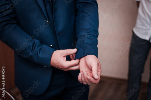 Man straightens the jacket sleeve