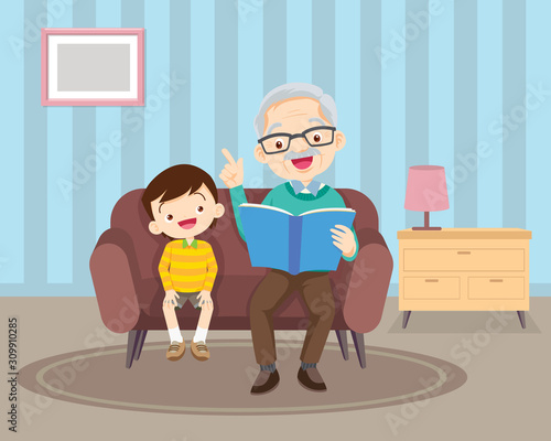 grandfather with grandchildren reading on sofa