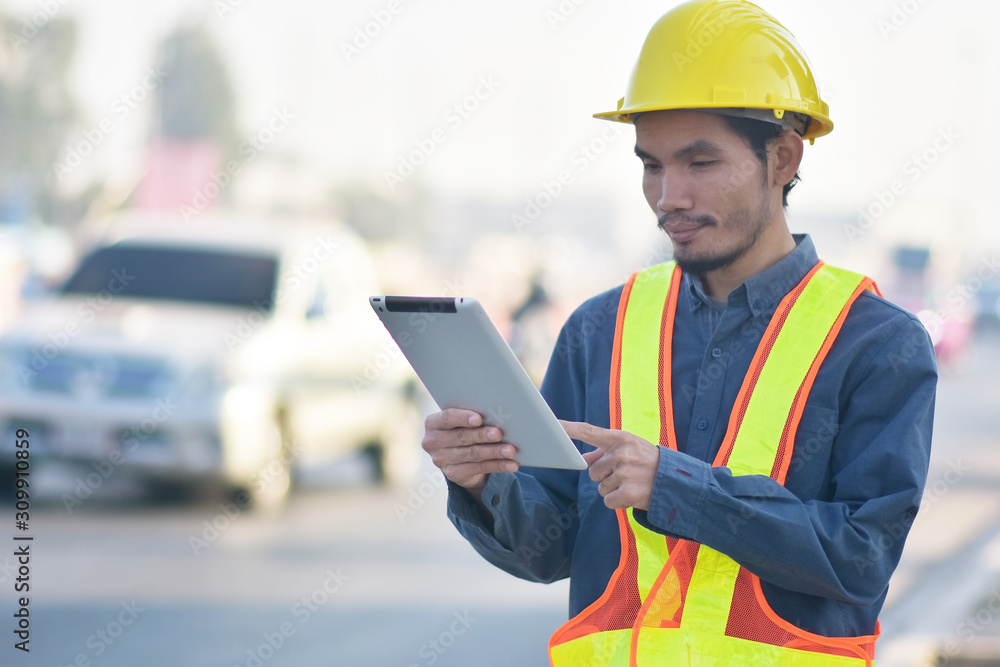 Engineering Holding tablet Highway transportation on road background,Engineer use tablet technology analysis data to planing work construction Engineering Holding tablet Highway transportation on road background,Engineer use tablet technology analysis data to planing work construction