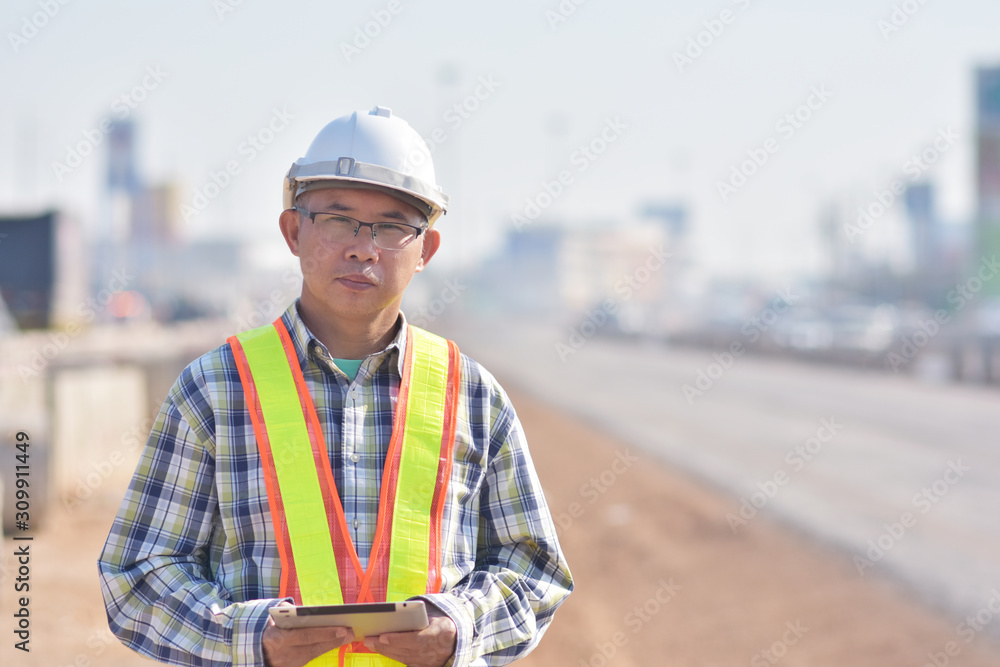 Senior Engineering worker by tablet inspection on site road construction Senior Engineering worker by tablet inspection on site road construction