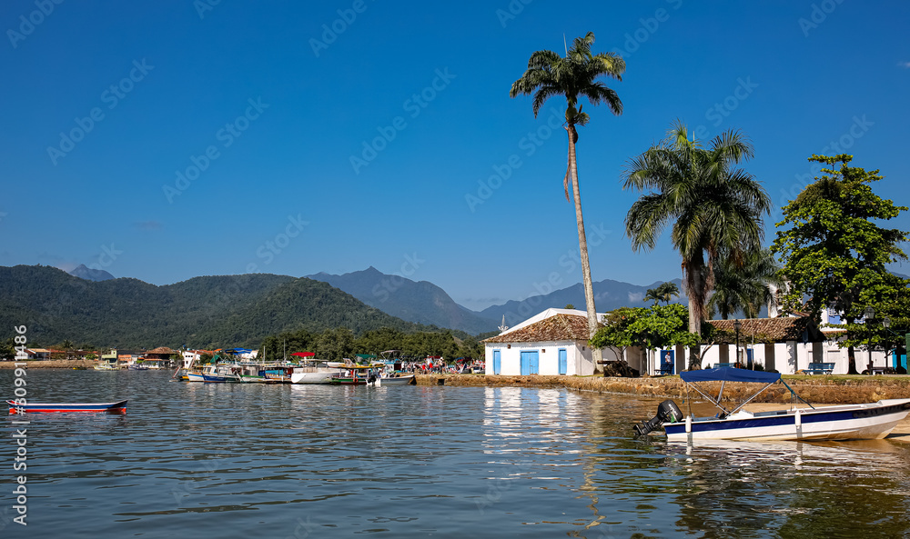 View to waterfront of historic town Paraty and Atlantic Forest mountains on a sunny day, Brazil, Unesco World Heritage 