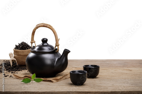 Cup of hot tea with teapot, green tea leaves and dried herbs on the wooden table isolate white background with empty space, Organic product from the nature for healthy with traditional