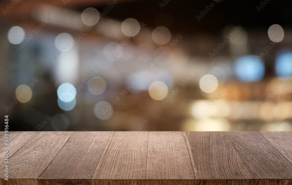 Empty dark wooden table in front of abstract blurred bokeh background of restaurant . can be used for display or montage your products.Mock up for space.