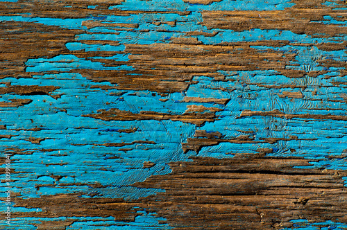 old painted background with cracked paint. Textural background.