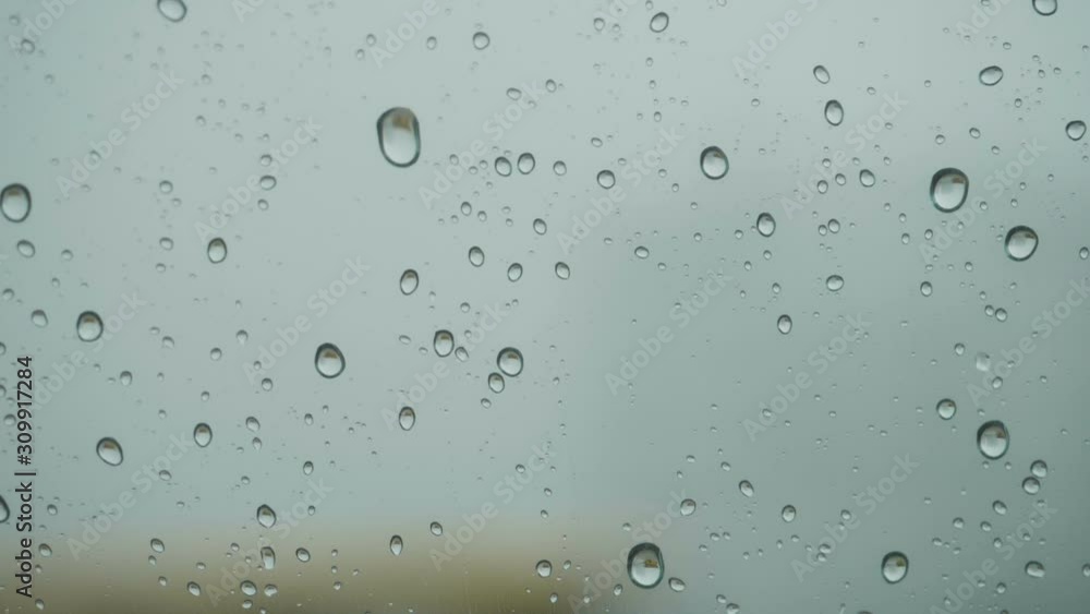 Rain On Glass Of Window With Outside. Close Up. Slow Motion. Rain On Glass. Rain Drops Water On Car Window Background. Bad Weather Autumn. Rain On Glass Of Window With Outside. Close Up. Slow Motion. Rain On Glass. Rain Drops Water On Car Window Background. Bad Weather Autumn.