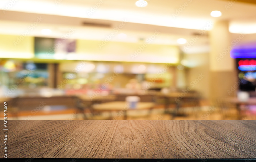 Empty dark wooden table in front of abstract blurred bokeh background of restaurant . can be used for display or montage your products.Mock up for space.