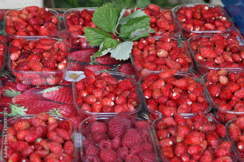 Fruit market in France. Ripe red strawberries in the boxes, decorated with green strawberry leaf