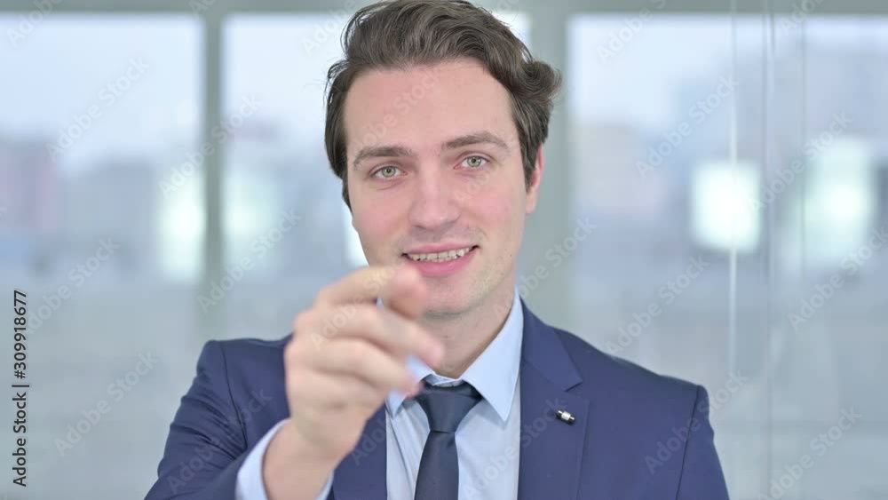 Portrait of Young Businessman Pointing Finger and Inviting Portrait of Young Businessman Pointing Finger and Inviting