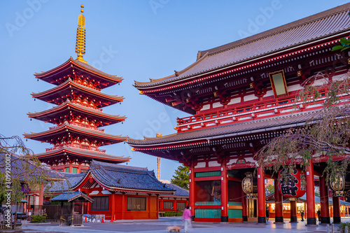 Japan. Tokyo. Gateway to Asakusa Temple in Japan. Huge paper lantern with hieroglyphs on goal. Pagoda of Sensoji Temple ? Tokyo. Gates Caminarimon in Tokyo. Human enters a Buddhist temple.