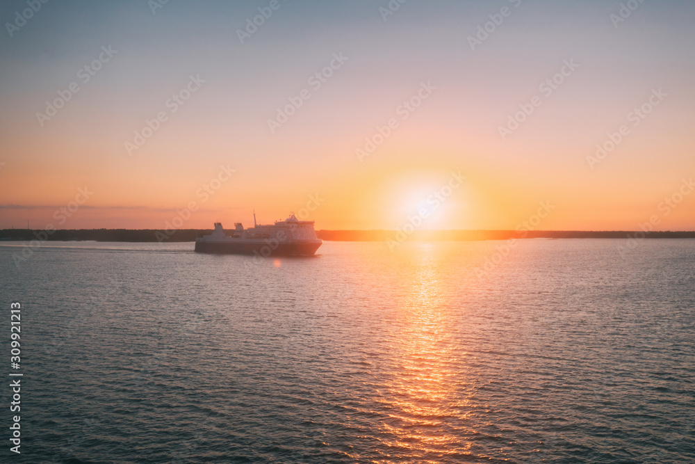 Stockholm, Sweden. Tourist Ship Or Ferry Boat Boat Liner Floating Near Islands In Summer Evening. Beautiful Seascape In Sunset Sunrise Time. Sun Sunshine Above Islands Archipelago