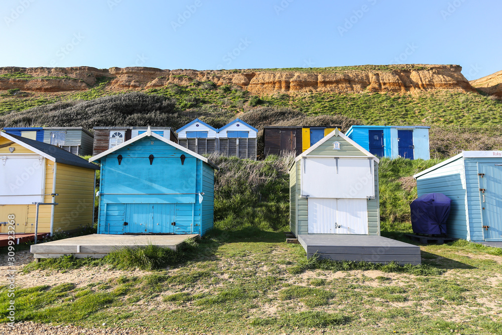 Beach Huts against a sandy cliff in Hampshire, South of England Beach Huts against a sandy cliff in Hampshire, South of England