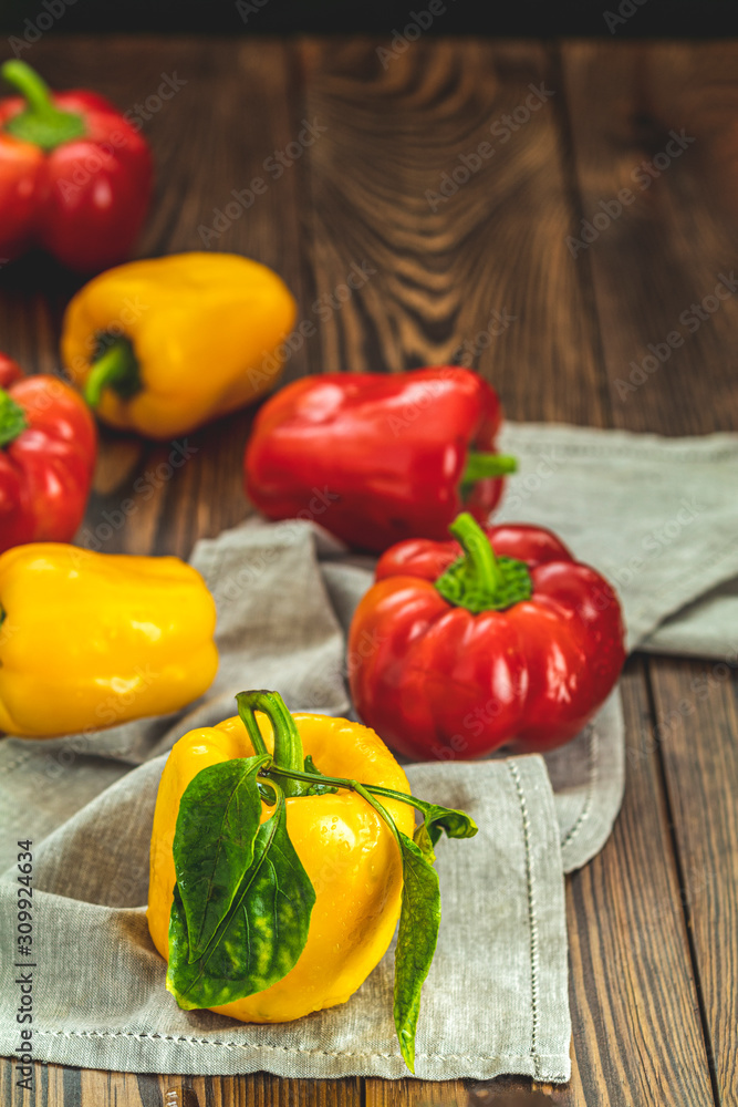 Ripe organic fresh sweet red and yellow pepper on dark wooden table. Selection of healthy food for heart, life concept Ripe organic fresh sweet red and yellow pepper on dark wooden table. Selection of healthy food for heart, life concept