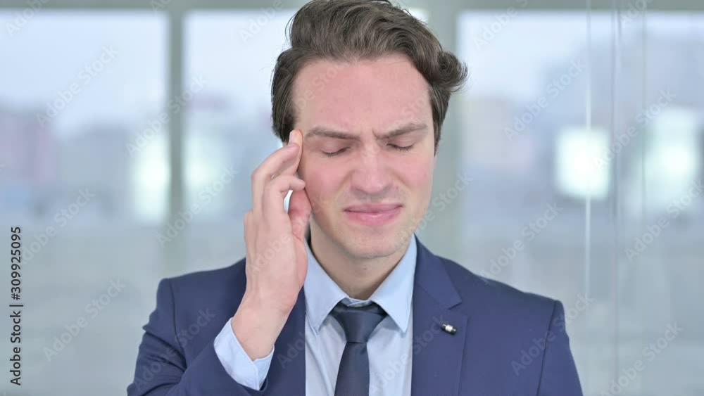 Portrait of Stressed Young Businessman having Headache Portrait of Stressed Young Businessman having Headache