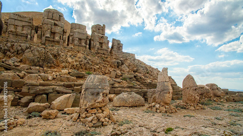 Panoramic view of some of the statues near the peak of Nemrut Dagi. King Antiochus I Theos of Commagene built on the mountain top of Mount Nemrut a tomb-sanctuary flanked by huge statues. Turkey