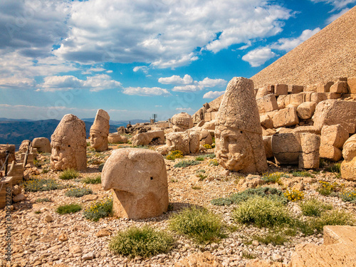 Panoramic view of some of the statues near the peak of Nemrut Dagi. King Antiochus I Theos of Commagene built on the mountain top of Mount Nemrut a tomb-sanctuary flanked by huge statues. Turkey