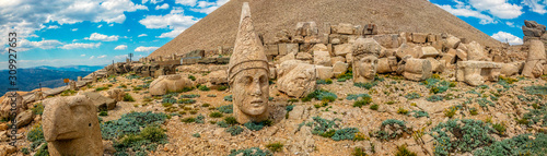 Panoramic view of some of the statues near the peak of Nemrut Dagi. King Antiochus I Theos of Commagene built on the mountain top of Mount Nemrut a tomb-sanctuary flanked by huge statues. Turkey