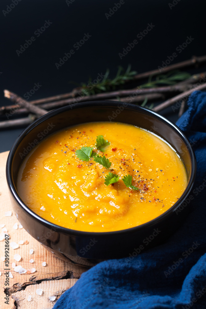 Healthy food concept Warm vegan mix vegetable soup in black ceramic cup with copy space Healthy food concept Warm vegan mix vegetable soup in black ceramic cup with copy space