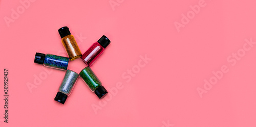 Colorful glitters, sun shape, on a flat lay photo, can fit for banners or craft instagram, with a pink background