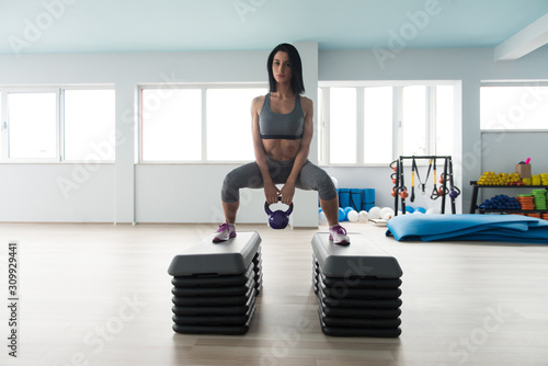 Healthy Young Woman Doing Exercise With Kettle Bell