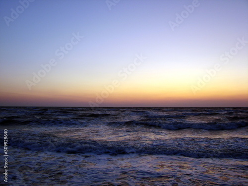 Panorama of the endless horizons of the Sea of ​​Azov under the morning sun at dawn.
