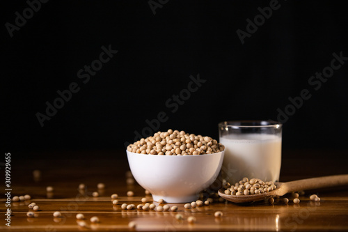 Soy milk hot and soybeans on wooden table background