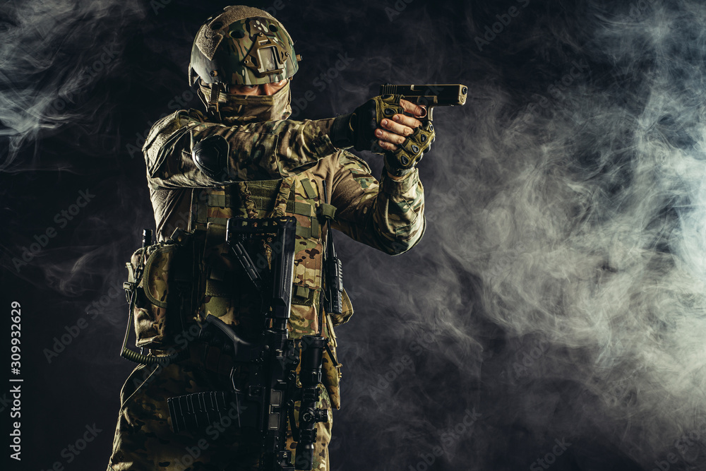 special forces soldier man holding machine gun and military equipment in smoky space special forces soldier man holding machine gun and military equipment in smoky space