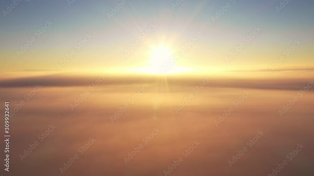 Aerial shot over the clouds, drone flying towards Vibrant Sun at golden hour. bright sunrays in heaven Aerial shot over the clouds, drone flying towards Vibrant Sun at golden hour. bright sunrays in heaven