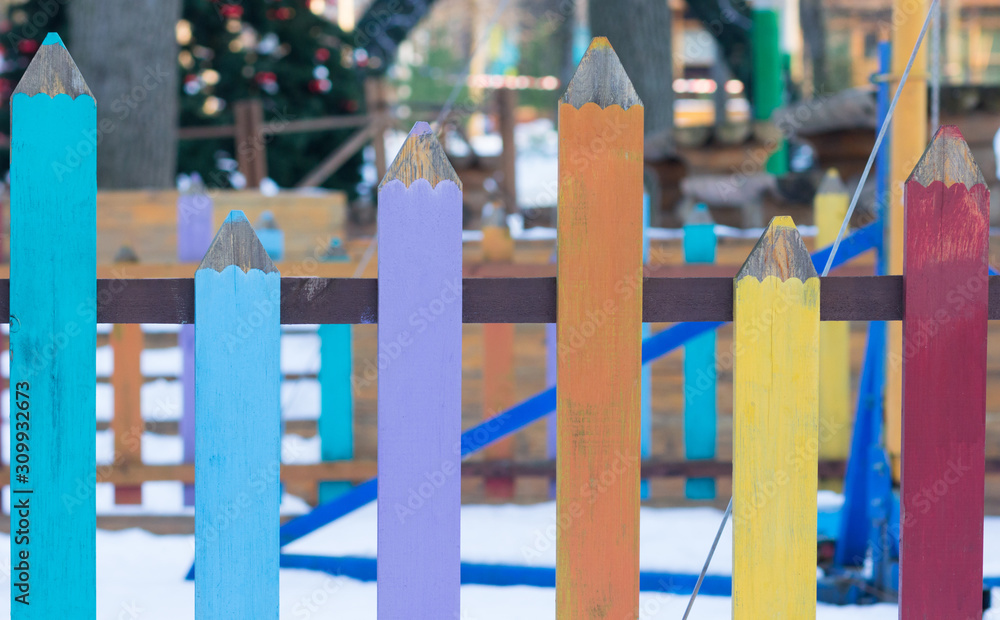 Colorful fence in the shape of pencils outside