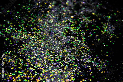 A colorful glitter on black background. Decorative colorful circles in the background