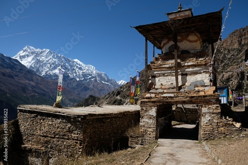 Traditional stone chorten being a gate in Himalayan village Ghyaru, Nepal. During trekking around Annapurna, Annapurna Circuit photo