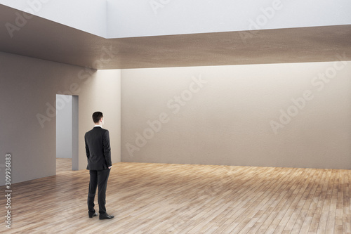 Businessman looking on empty wall