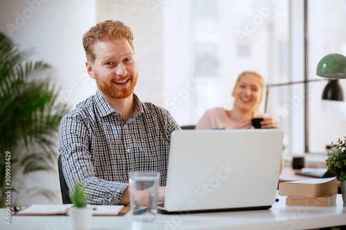 Businessman at office working. Attractive red hair businessman. 