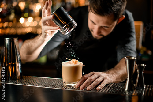 Wallpaper Mural Bartender sprinkles an alcohol cocktail with sour mix and candy Torontodigital.ca